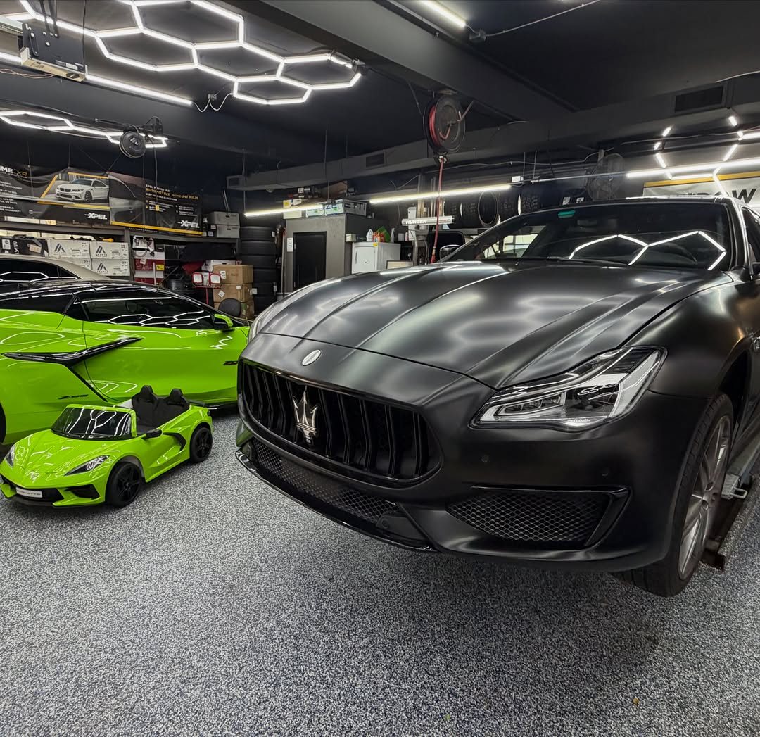 Maserati in satin black vinyl wrap inside the shop