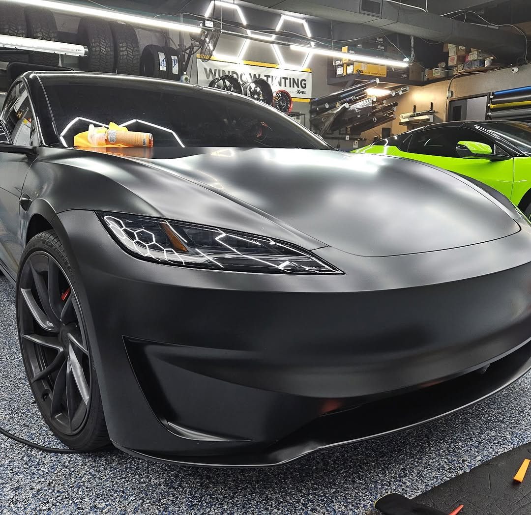 Tesla with satin XPEL Stealth paint protection film inside the shop