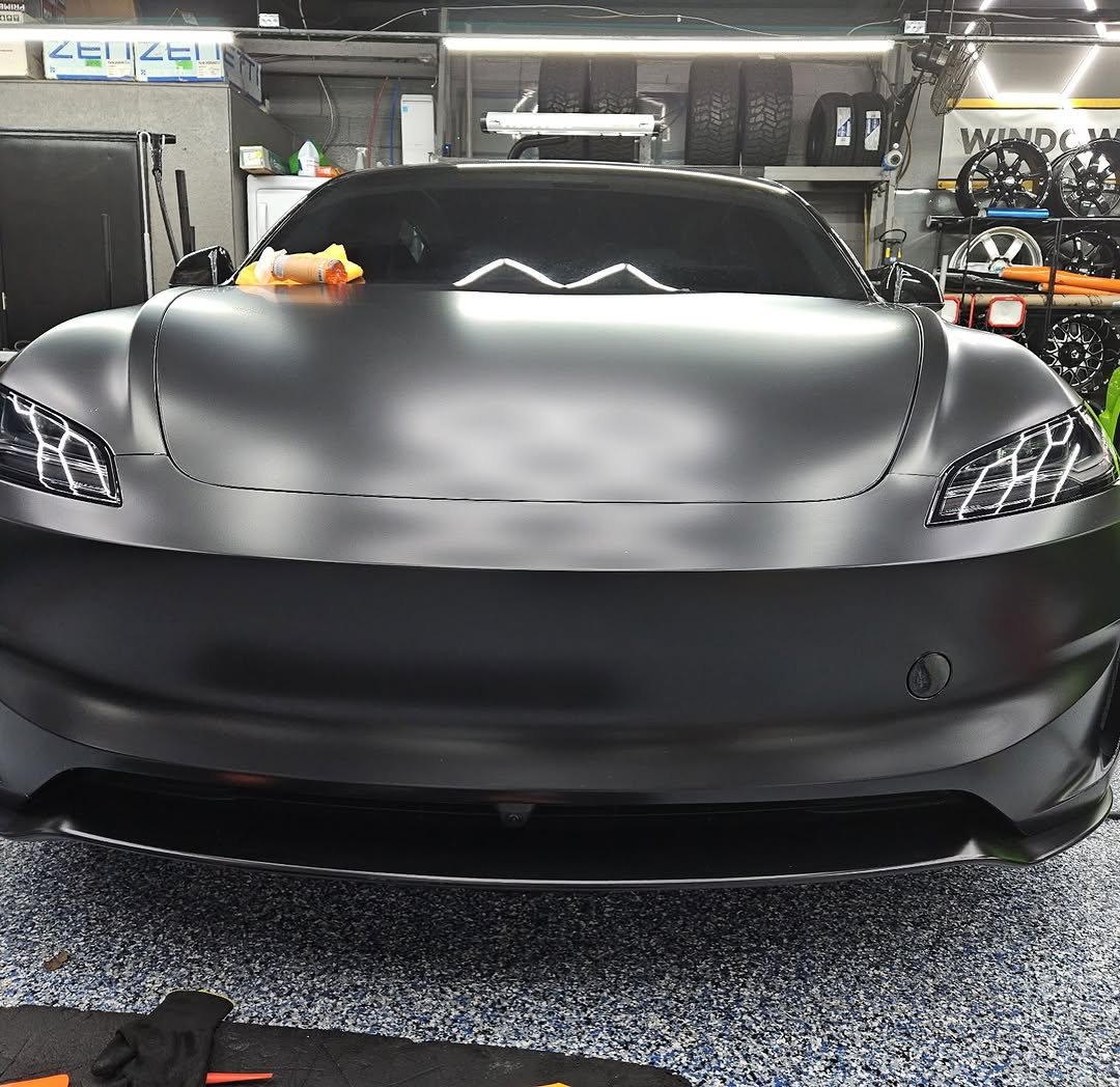 Front of a Tesla with satin paint protection film in the shop
